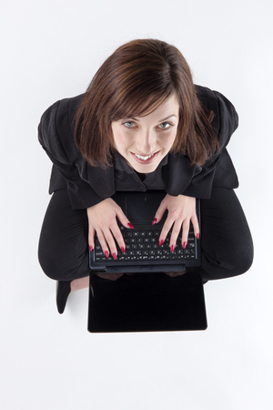 business woman sitting on the ground shot from aboveの写真素材