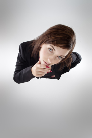business woman shot from above looking up at cameraの写真素材