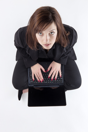 business woman sitting on the ground shot from aboveの写真素材