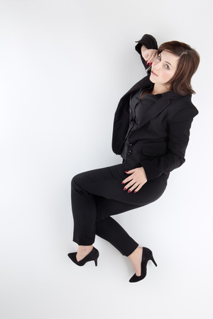 business woman on the phone lying on the ground shot from aboveの写真素材