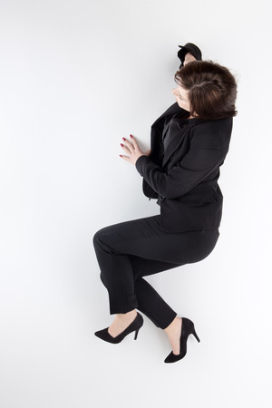 business woman on the phone lying on the ground shot from aboveの写真素材