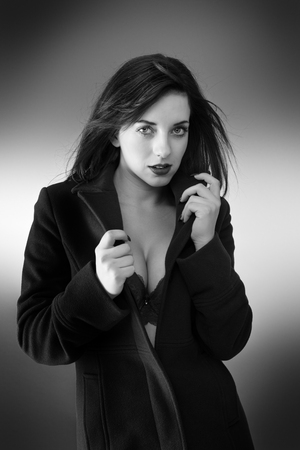 young sexy woman wearing a long coat with and just underwearの写真素材