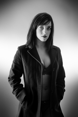 young sexy woman wearing a long coat with and just underwearの写真素材