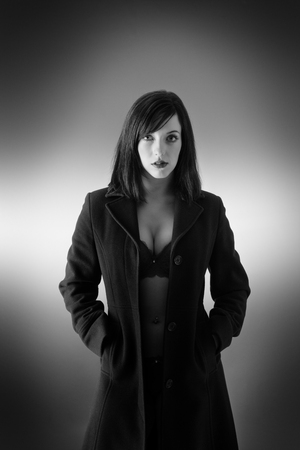 young sexy woman wearing a long coat with and just underwearの写真素材