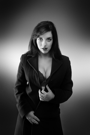 young sexy woman wearing a long coat with and just underwearの写真素材
