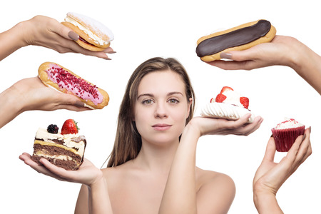 woman surrounded by many cakesの写真素材