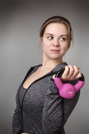 young model holding a kettlebell の写真素材