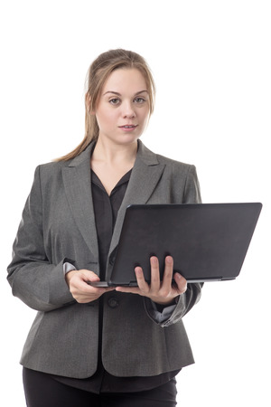 standing young business woman using a computer の写真素材