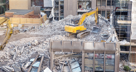 building site with heavy machinery knocking down a building to make way for something newの写真素材