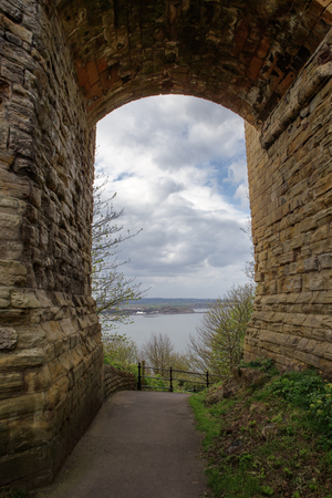 archway under a castle looking out to the seaの写真素材