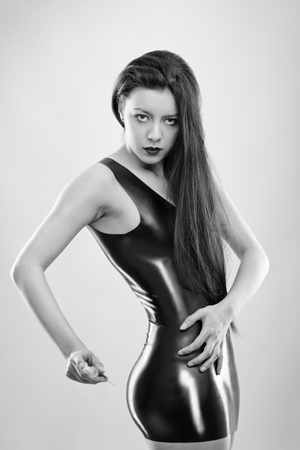 studio image of young woman wearing latexの写真素材