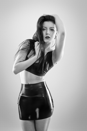 studio image of young woman wearing latexの写真素材