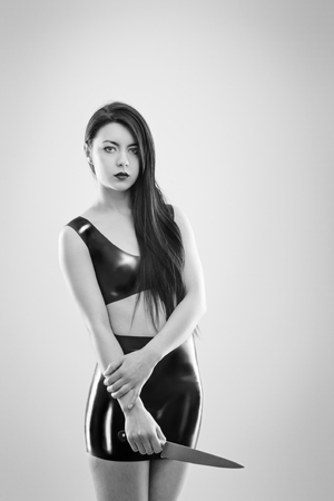 studio image of young woman wearing latexの写真素材