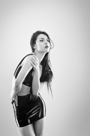 studio image of young woman wearing latexの写真素材