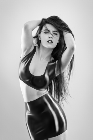 studio image of young woman wearing latexの写真素材
