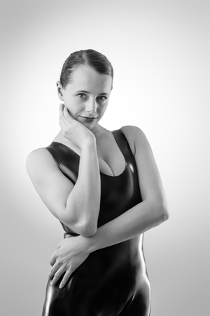 Studio black and white image of young woman wearing latexの写真素材