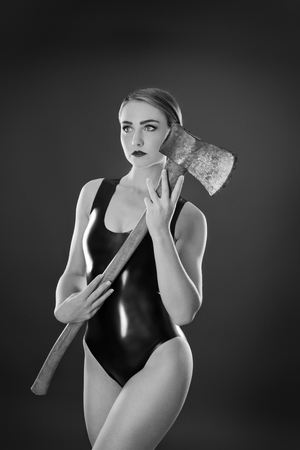 Studio black and white image of young woman wearing latexの写真素材