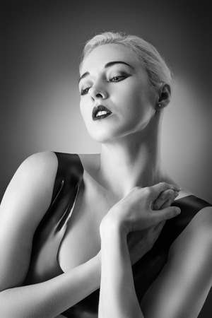 Studio black and white image of young woman wearing latexの写真素材