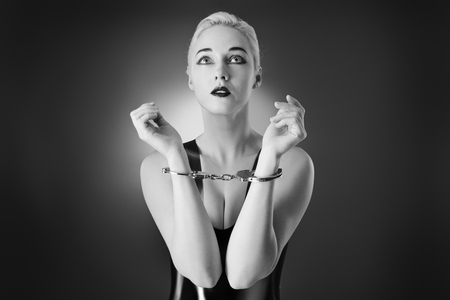 Studio black and white image of young woman wearing latexの写真素材