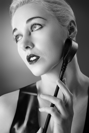 Studio black and white image of young woman wearing latexの写真素材