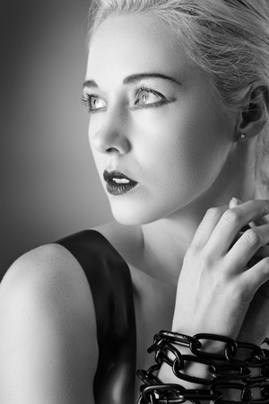 Studio black and white image of young woman wearing latexの写真素材