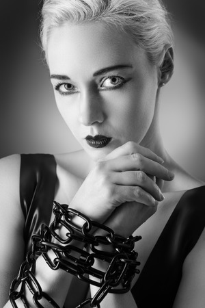 Studio black and white image of young woman wearing latexの写真素材