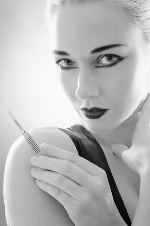 Studio black and white image of young woman wearing latexの写真素材