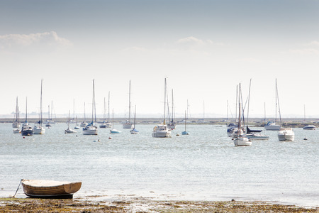 landscape image of boats on the sea taken from west mersea in essex englandの写真素材