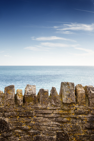 seascape image looking out over a old stone wallの写真素材