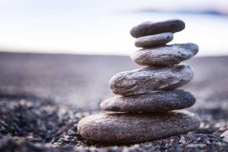 Rock balancing or stone balancin,  naturally balanced on a beach with the sea behindの写真素材
