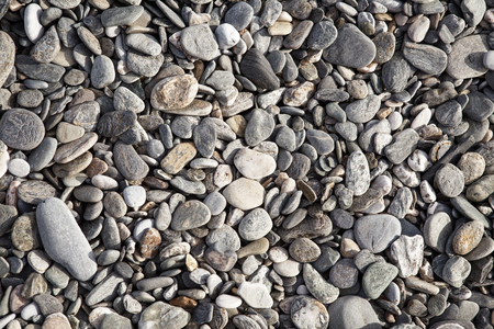 many gray stones and pebbles on the floorの写真素材
