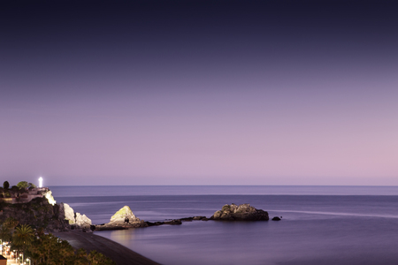 sunset in the costa tropical almunecar spain with the large cross of Penones del Santo in the backgroundの写真素材