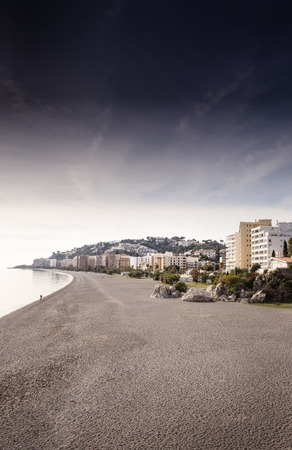 landscape image of the town almunecar in spain showing the beach and the townの写真素材