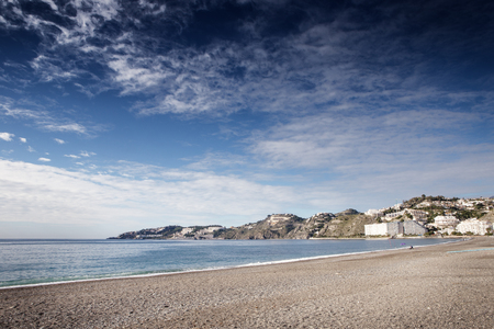 landscape image of the town almunecar in spain showing the beach and the townの写真素材
