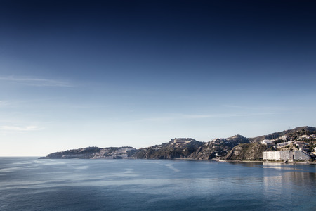 landscape image of the town almunecar in spain showing the beach and the townの写真素材