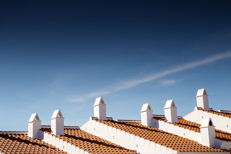 chimleys on the roof top of building in spainの写真素材