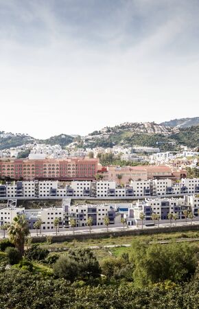 apartment and houses build on the side of a mountain in spainの写真素材