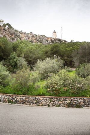 looking up from the road at the old Faro De La Herradura lighthouse in almunecar spainの写真素材