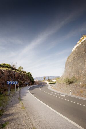 bend in road build into a mountain in spainの写真素材