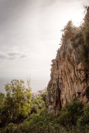 rock face cliff top with forest below in spain