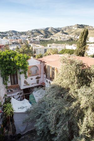 run down back garden with the mountains of almunecar in the backgroundの写真素材