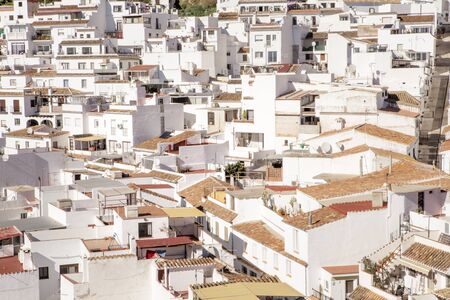 hillside town of mijas with lots of whitewash building and homes build into the hillsideの写真素材