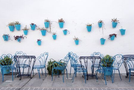 traditional blue flower pots hanging on a whitewashed wall in mijas spainの写真素材