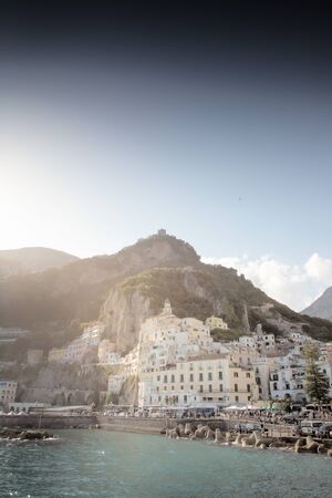 coastline of amalfi with the backdrop of the mountains and buildingの写真素材