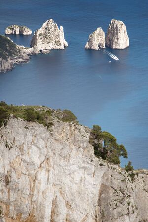 view point on mount solaro looking down at the three towering rock formations of Faraglioni の写真素材