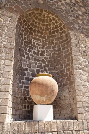 large  urn in a alcove in a brick wallの写真素材