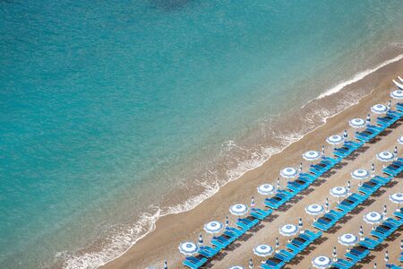 looking down at beach with beach lounger and sun umbrella from aboveの写真素材