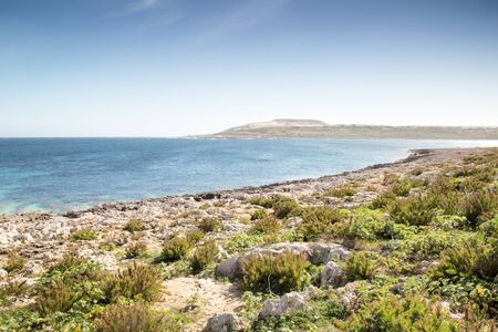 stoney beach in malta looking down the coastline at Maghtab  known for Malta's largest landfil that is now closedの写真素材