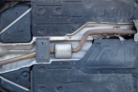 underside of car showing the exhaust and all the plastic partsの写真素材