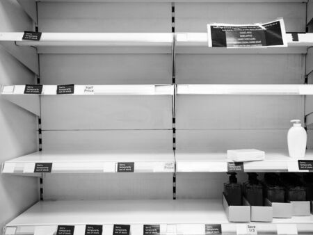 empty shalf sold out of hand sanitizer and soapの写真素材